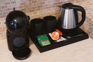 a coffee maker and a tea kettle on a counter at Amaryllis Suites Santorini in Fira