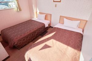 Postel nebo postele na pokoji v ubytování Hotel Select Inn Sano-Ekimae