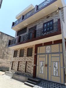 a building with two garage doors in front of it at Vallabh Kunj Sewa Sadan in Govardhan