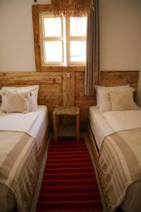 two beds in a room with a window at Grip Sea Morocco in Agadir