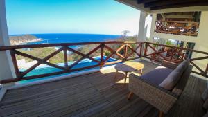 a balcony with a view of the ocean at Casa Sacre in Cuatunalco +8 photos
