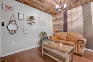 a living room with a couch and a table at Peaceful Studio & Work Friendly Walk to Hyde Park in Tampa