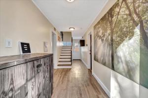 a hallway with a staircase and a painting on the wall at Peaceful Studio & Work Friendly Walk to Hyde Park in Tampa