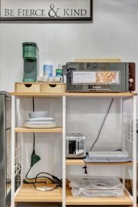 a shelf with a microwave and a toaster on it at Peaceful Studio & Work Friendly Walk to Hyde Park in Tampa