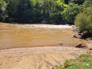 a view of a river with trees in the background at Parque Parapirá Camping in Socorro