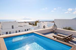 a pool on the roof of a house with a view at Amaryllis Suites Santorini in Fira