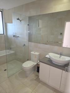 a bathroom with a toilet and a sink and a shower at SeymourViews Apollo Bay in Apollo Bay +18 photos