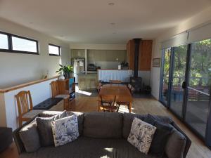 a living room with a couch and a table at SeymourViews Apollo Bay in Apollo Bay