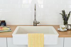 a white sink in a kitchen with a faucet at UzuriBarossa in Altona +17 photos