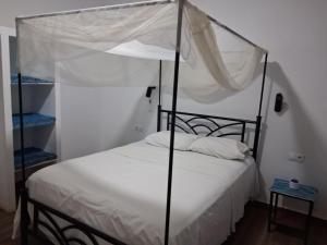 a bedroom with a bed with a canopy at VILLA KEUR BAYE FALL Saly in Sali Nianiaral +67 photos