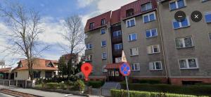 a building with a red sign in front of it at Casa Castillo Toruń in Toruń