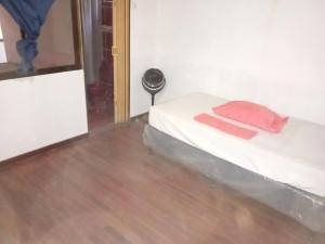 a bedroom with a bed and a wooden floor at El Cacique in Alajuela