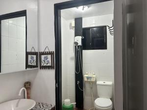 a bathroom with a toilet and a mirror at Anabelle Residence in Dumaguete