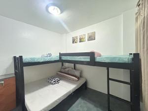 a bedroom with two bunk beds in a room at Anabelle Residence in Dumaguete