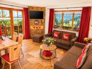 a living room with a couch and a table at Gästehaus Schönfeld in Reit im Winkl