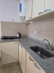 a kitchen with a sink and a counter top at Rincón Esmeralda in Mercedes