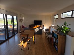 a living room with a table and a couch at SeymourViews Apollo Bay in Apollo Bay