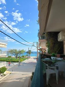 a patio with a table and chairs and the beach at NiK Seaview Suite Balcony Steps from Beach in Flogita
