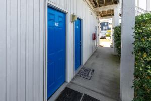 a pair of blue doors on a building at Co Sea Casa in Carolina Beach