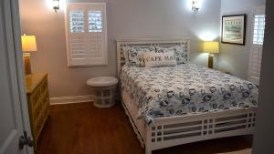 a bedroom with a white bed and a window at Sunset Shore House Second Floor in West Cape May