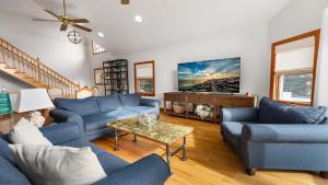 a living room with blue couches and a table at Sunset Sands And Sea Dogs in West Cape May