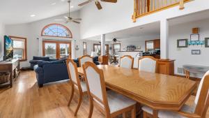 a dining room and living room with a wooden table and chairs at Sunset Sands And Sea Dogs in West Cape May