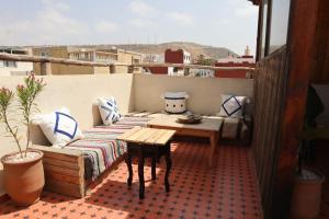 a balcony with a couch and a table on a roof at Grip Sea Morocco in Agadir +102 photos