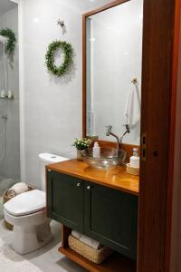 a bathroom with a sink and a toilet at HolzHaus em Pomerode in Pomerode +12 photos