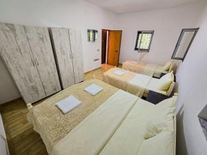 a small room with two beds in it at Arditi's Villa in Shkodër +15 photos
