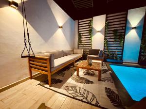a living room with a couch and a pool at Casa Luque in Culiacán