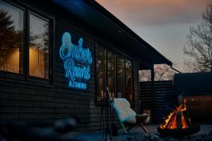 a building with a neon sign on the side of it at Ember Resort AZUMIMO 静寂の森に佇むプライベートサウナ付き一棟貸しリトリート in Azumino +99 photos