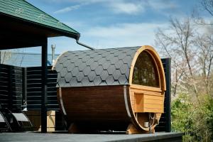 a small wooden boat sitting next to a house at Ember Resort AZUMIMO 静寂の森に佇むプライベートサウナ付き一棟貸しリトリート in Azumino