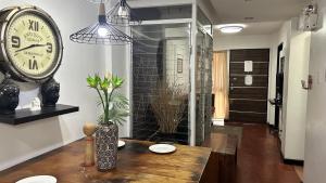 a room with a table and a clock on the wall at Anabelle Residence in Dumaguete +45 photos