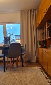 a dining room with a table and chairs and a window at PAE korter Kärdlas in Kärdla