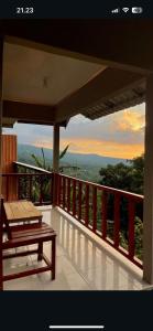 a balcony with a bench and a view of the ocean at Diva sunset garden in Senaru +23 photos
