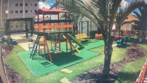 a playground with a slide and a tree at Apartamento com 02 quartos in Maceió