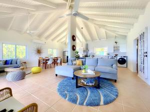 a living room with blue couches and a table at Clearview Villas Upper in Island Harbour
