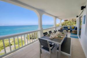 a dining room with a view of the ocean at Clearview Villas Upper in Island Harbour