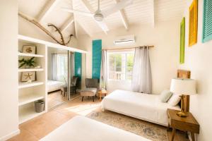 a bedroom with a white bed and a window at Clearview Villas Upper in Island Harbour