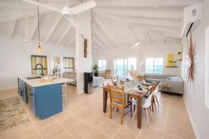 a kitchen and living room with a table and chairs at Clearview Villas Upper in Island Harbour