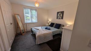 a small bedroom with a bed and a window at Large Modern House With Private Parking in Heeley