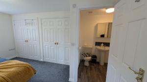 a white bathroom with a toilet and a sink at Large Modern House With Private Parking in Heeley +75 photos