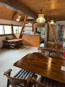 a restaurant with wooden tables and chairs and a counter at Yamadasan Ski Lodge - Madarao in Madarao Kogen