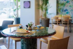a table with a plate of food on top of it at Business Hotel Hayashiso in Miyazaki