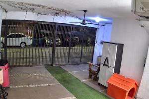 an entrance to a garage with a gate and grass at Comfort House in Manuel F. Martínez