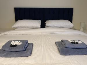 two towels on a bed with two pillows on it at No2 Back Lane in Thrussington