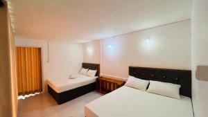 a small room with two beds and a window at The victoria hill Cottage in Digana +21 photos