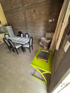 a dining room with a green table and chairs at Los Girasoles in Albardón