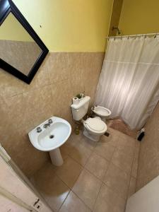 a bathroom with a sink and a toilet and a shower at Los Girasoles in Albardón