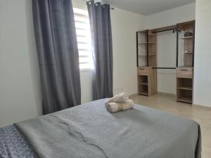 a bedroom with a bed with a towel on it at Bella - Destination Guyane in Rémire-Camp